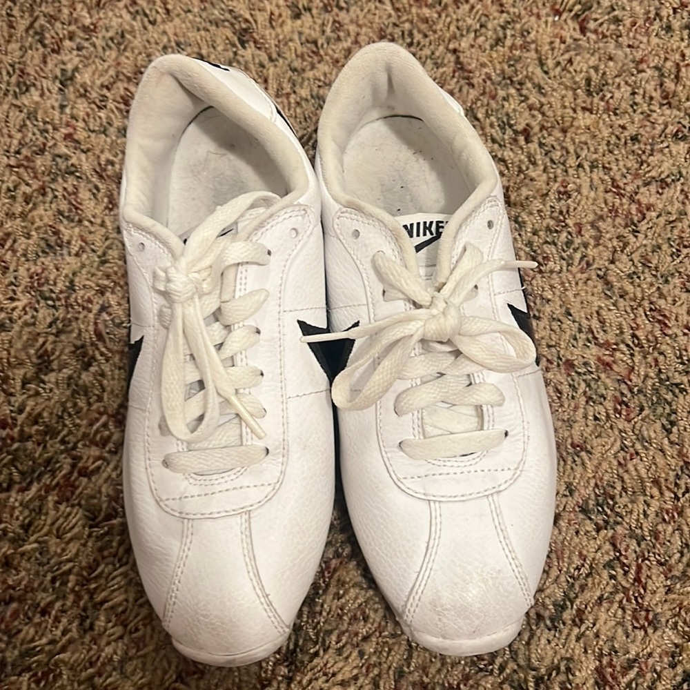 White Nike sneakers with black Nike swoosh